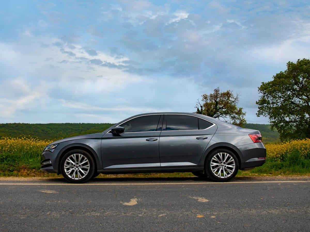Grey sedan parked on a countryside road